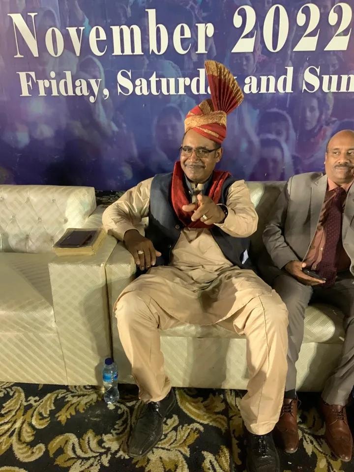 November 2022 Crusade — Pastor Larry Birgans seated at event